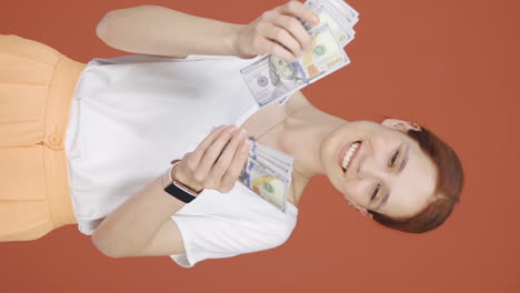 Vertical-video-of-Woman-counting-money-looking-at-camera.